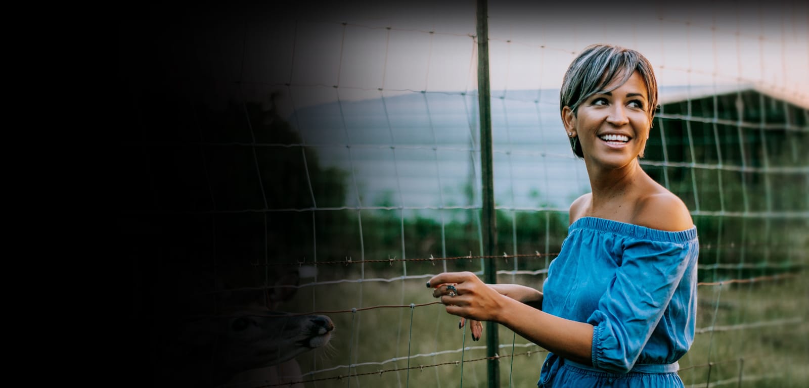 a person standing in front of a fence