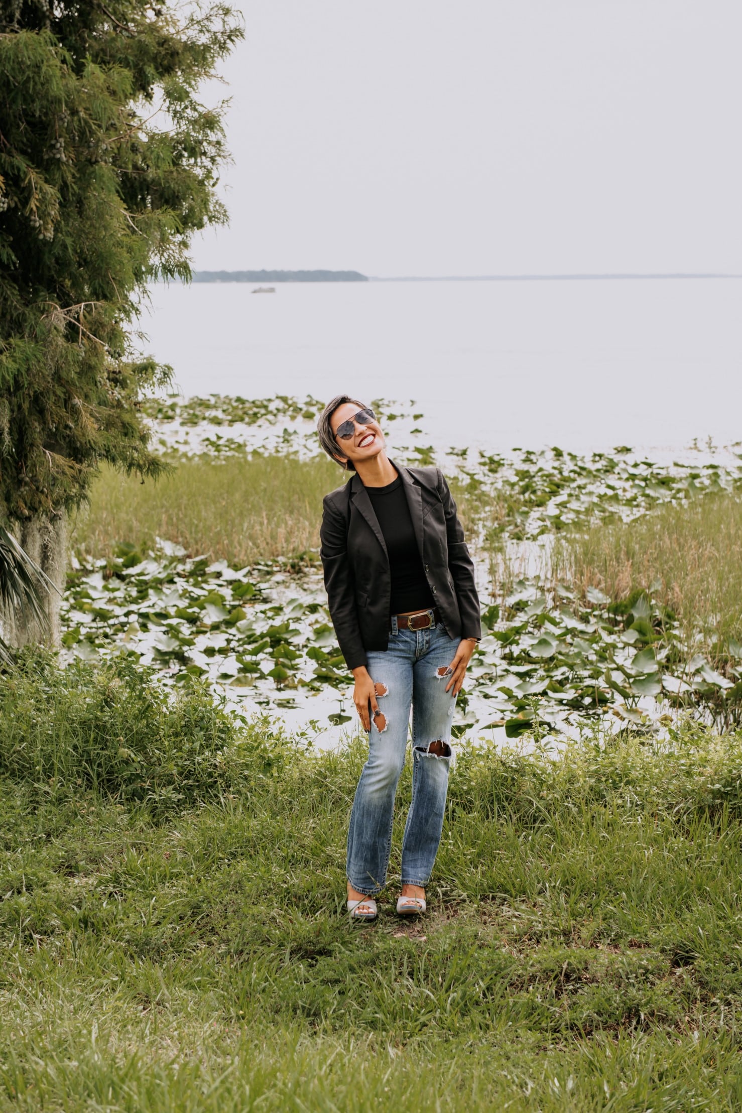 a man standing on top of a grass covered field